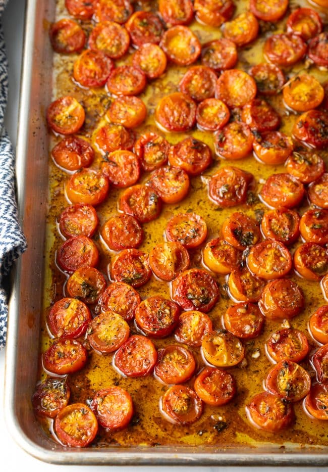 Overhead view tomatoes roasting in a pan.
