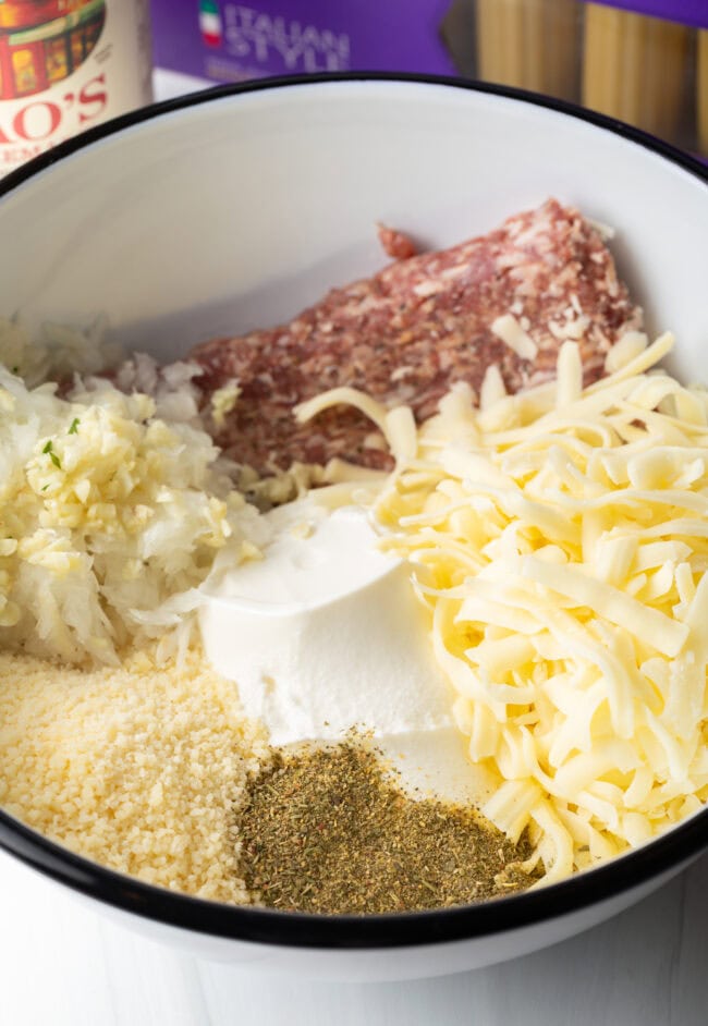 Cheese and meat filling ingredients in a large white bowl.