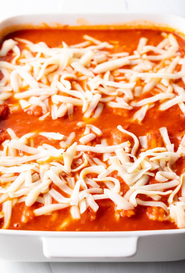 Shredded mozzarella cheese sprinkled on top of the pasta casserole.