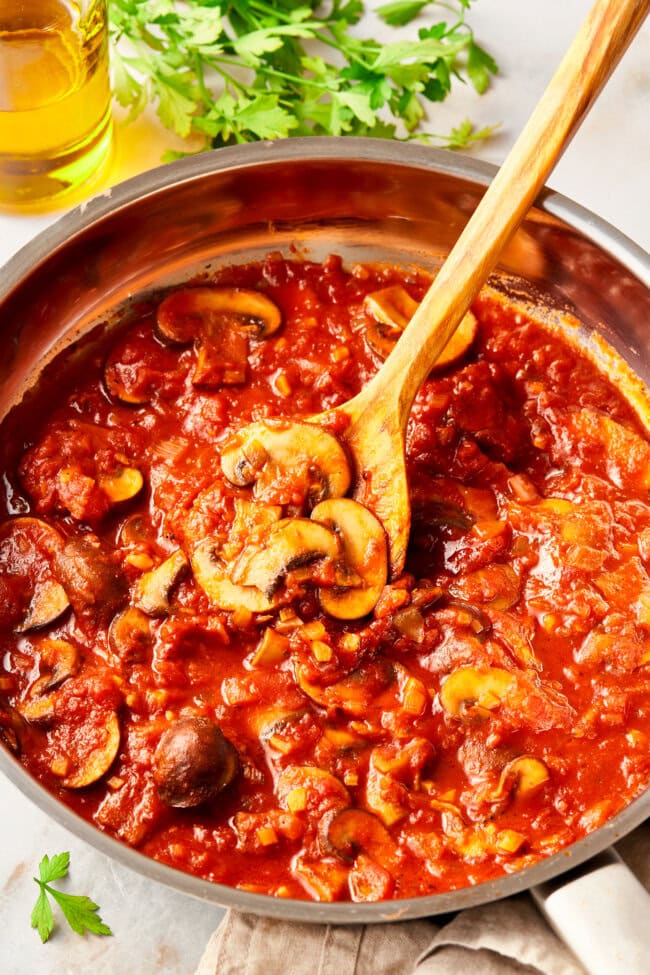 Mushrooms and Tomato Sauce in a large skillet for chicken cacciatore.