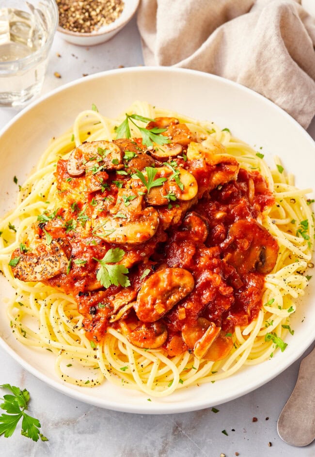 Chicken cacciatore on two white plates. 