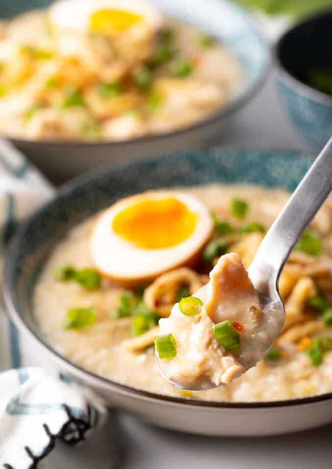 Instant pot congee jook rice porridge in a spoon held to camera.
