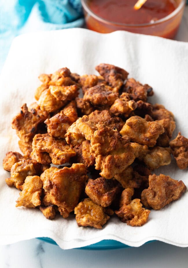 Fried chicken pieces on a paper towel.