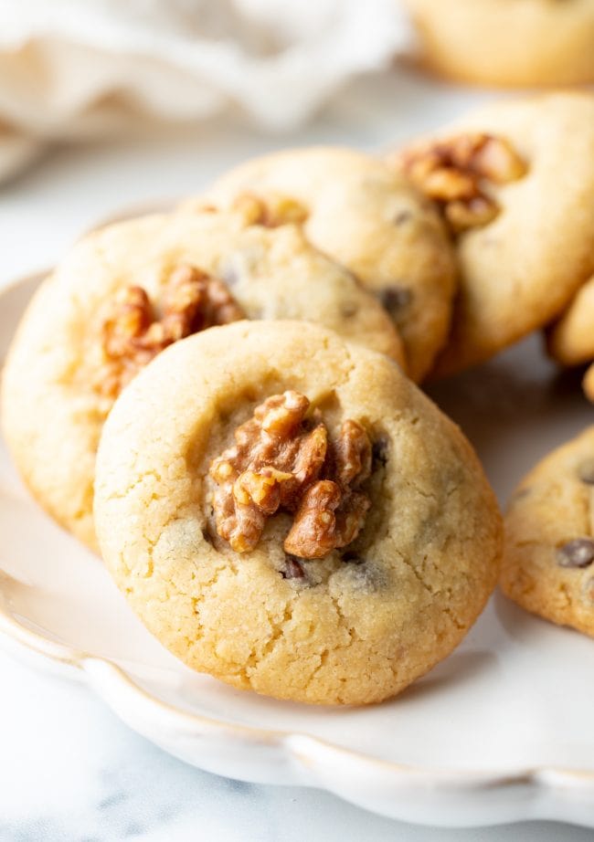 close view chocolate chip cookies with walnuts on a plate
