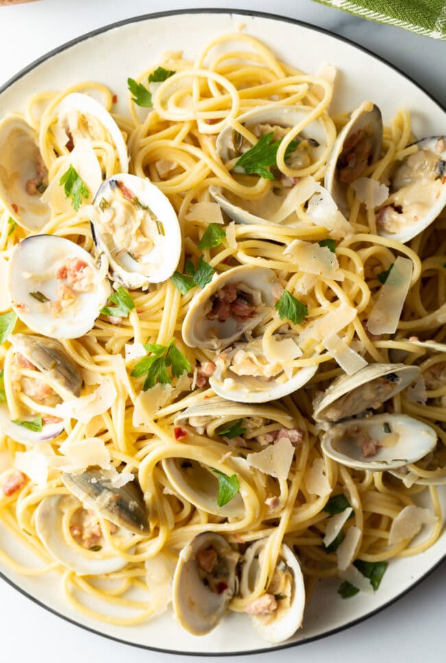 overhead shot of clams with pasta on platter 
