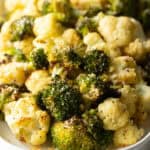 White oval platter loaded with roasted broccoli and cauliflower florets.