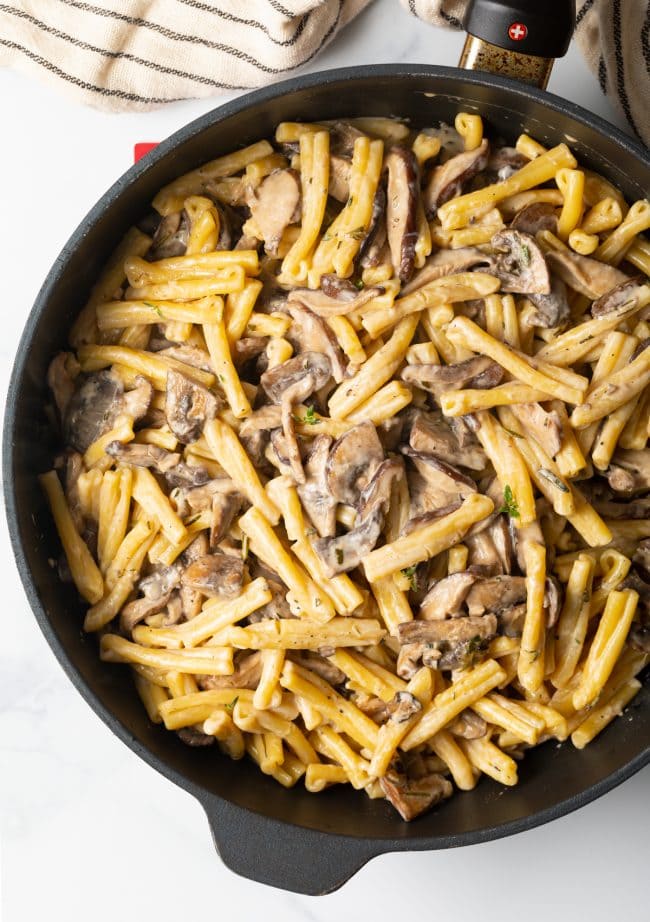 top view creamy gemelli mushroom pasta in a heavy skillet