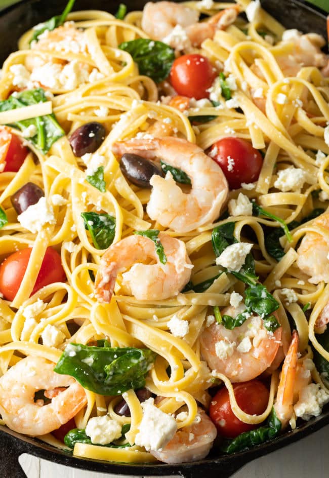 Mediterranean Shrimp Pasta in a cast iron skillet. 
