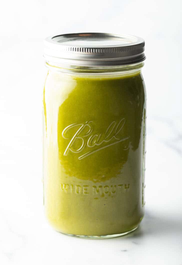 Large glass mason jar filled with green sauce.