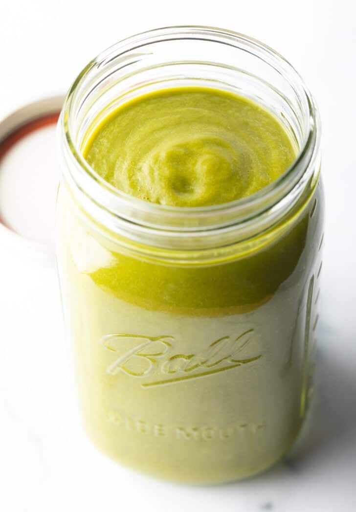 Large glass mason jar filled with green sauce.