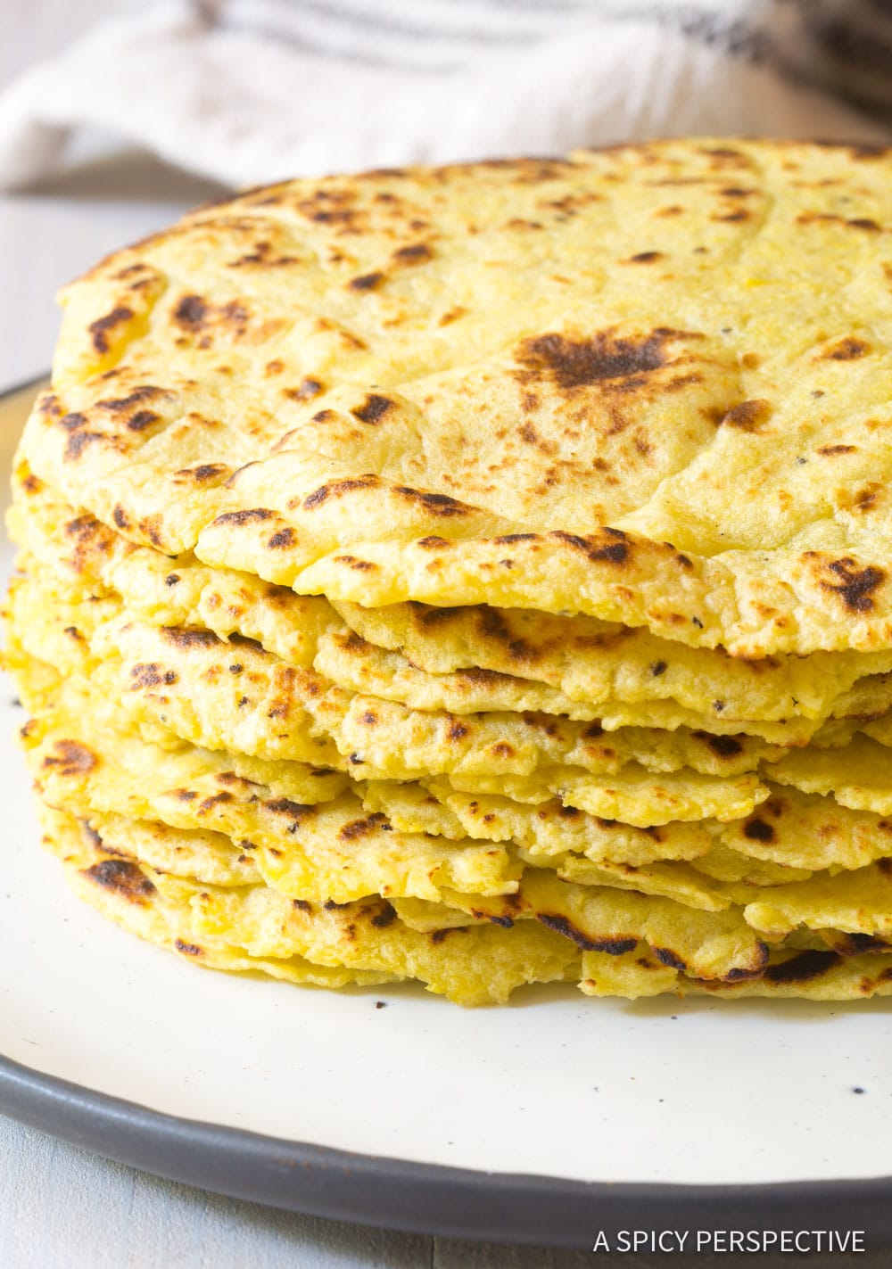 Plantain Wraps stacked high on a white plate.