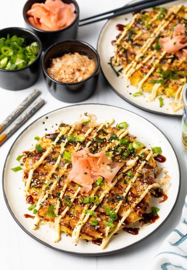 top view of okonomiyaki sauce topped Japanese pancake recipe with sushi add ons