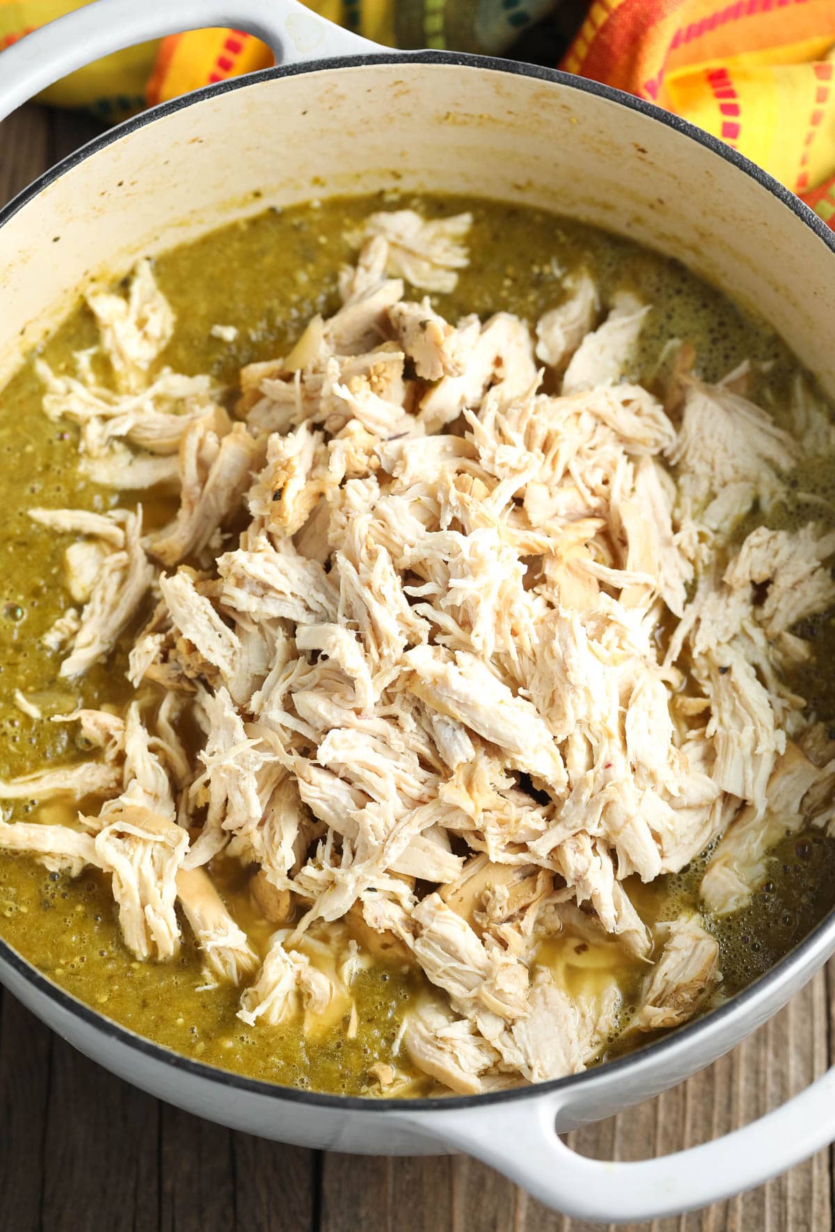 Shredded chicken breasts placed back in the pot with the chicken chili verde recipe 
