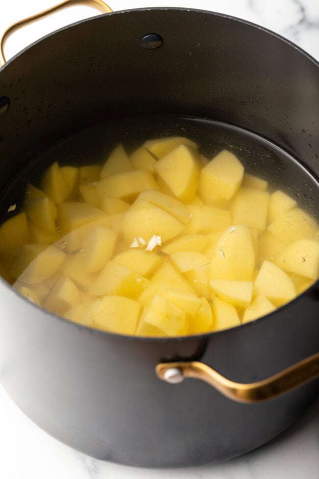 Cooking chopped potatoes in water.