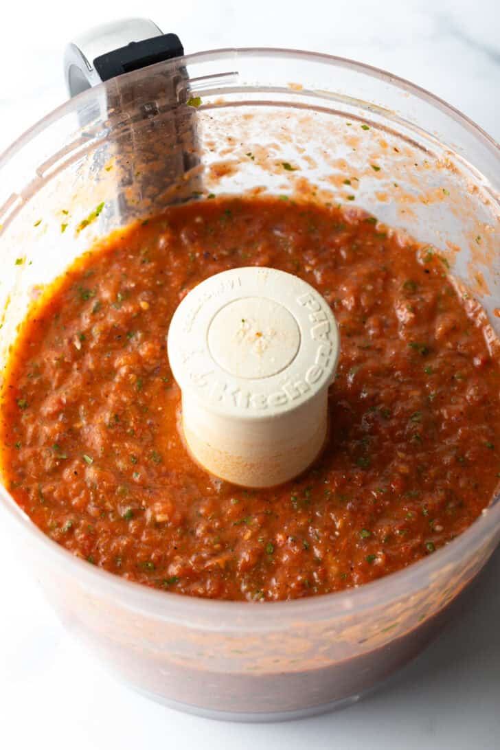 Food processor with fresh tomato salsa.