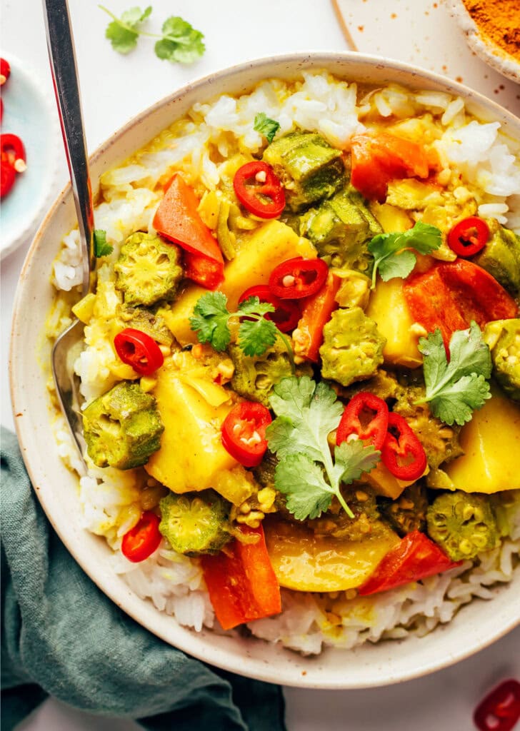 Perfect Island Slow Cooker Potato Curry Recipe over rice in bowl