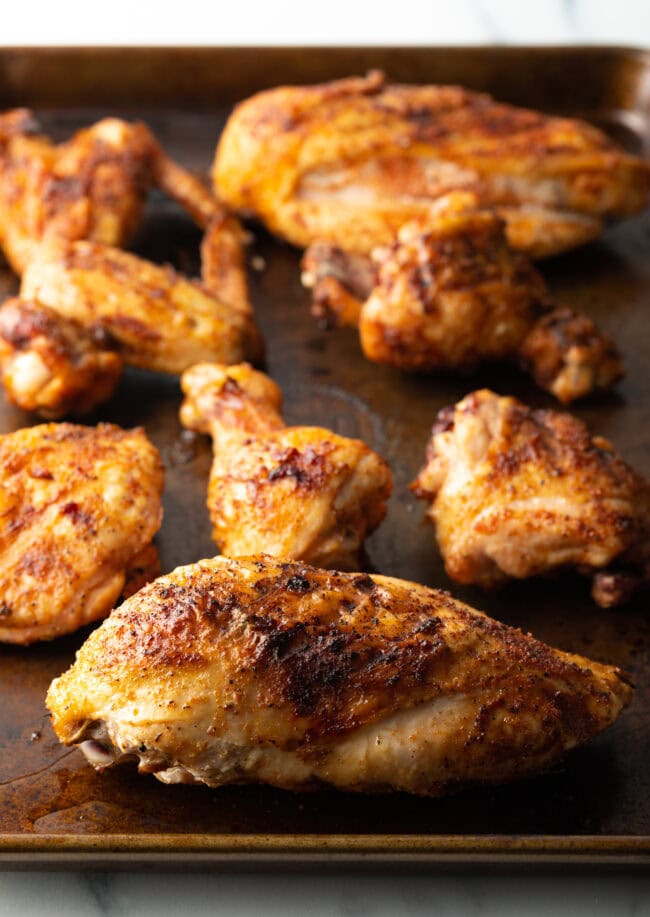 Smoked poultry pieces on a cutting board.