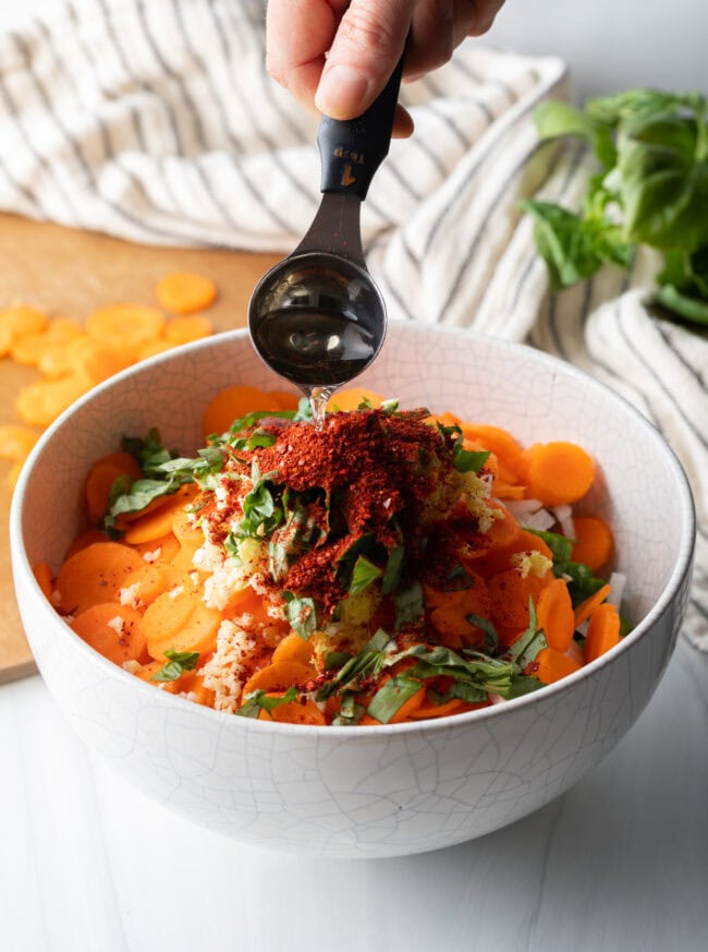 Adding sauces to the bowl.