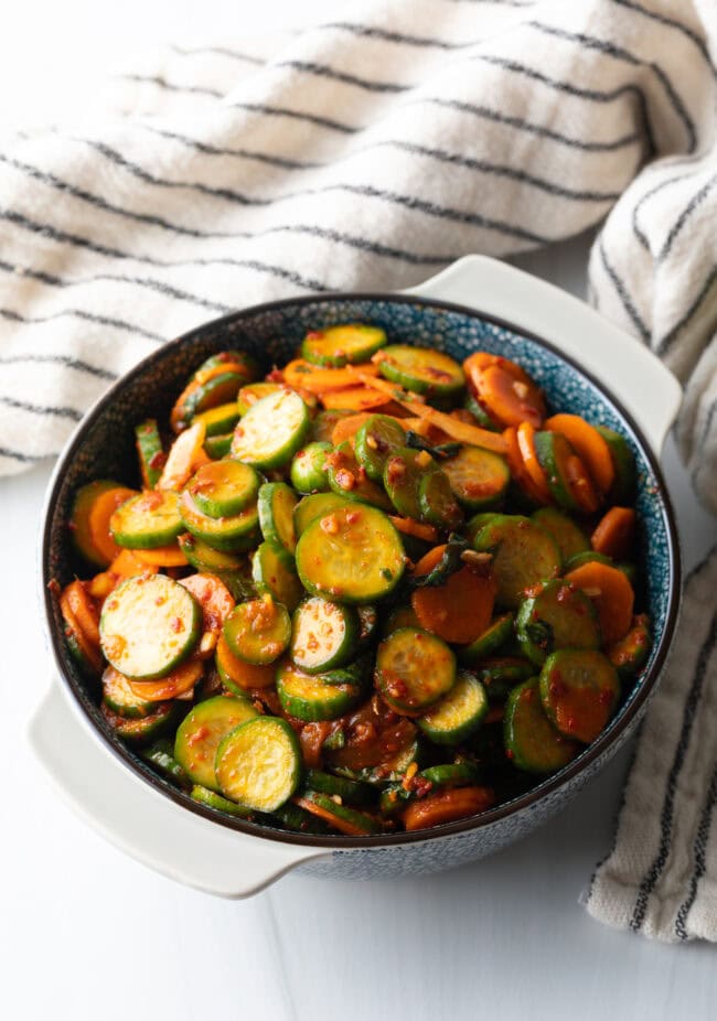 Serving of cucumber kimchi in a gray bowl.
