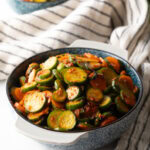 Serving of cucumber kimchi in a gray bowl.