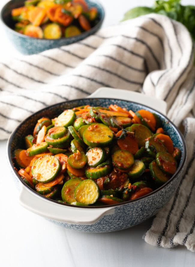 Serving of cucumber kimchi in a gray bowl.