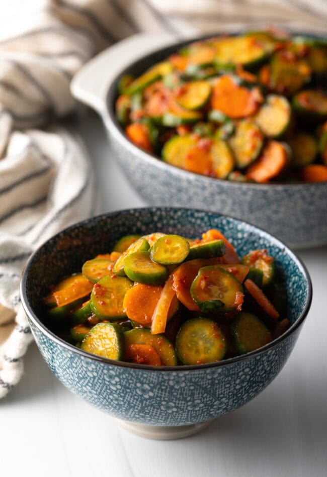 Serving of cucumber kimchi in a gray bowl.