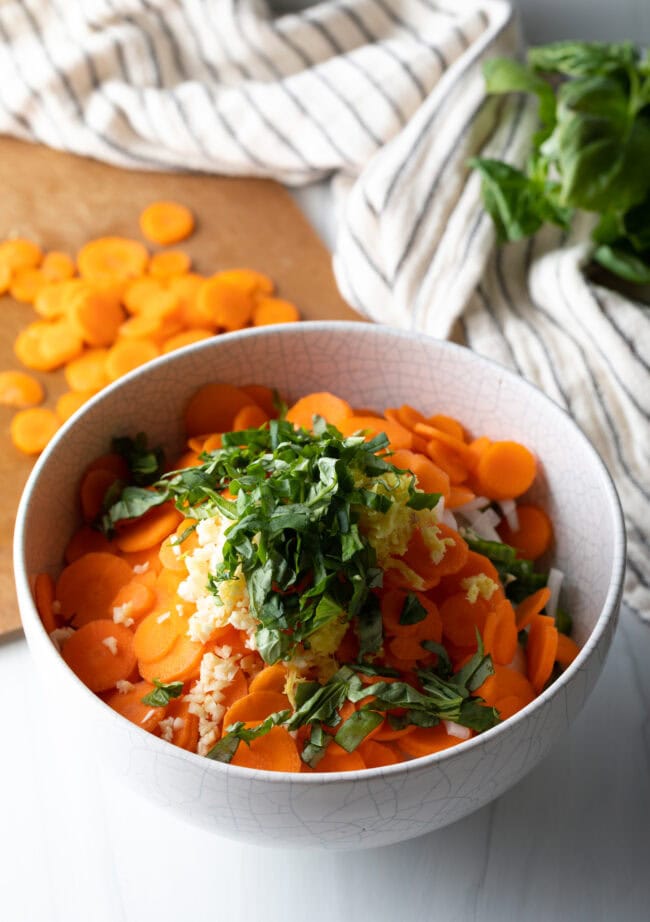 Adding fresh herbs to the bowl.