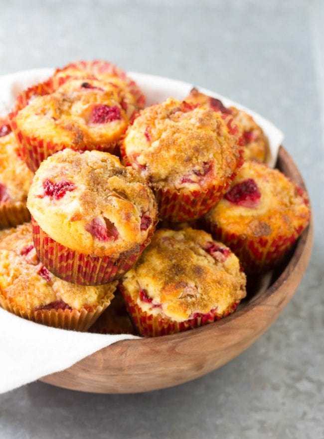 Strawberry rhubarb muffins in a large wooden bowl.