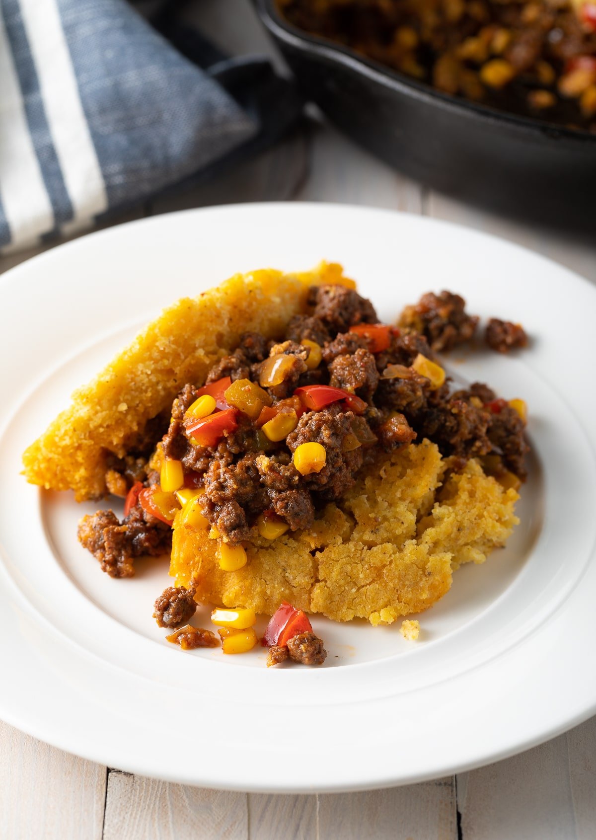Serving of tamale pie served on a white plate. 