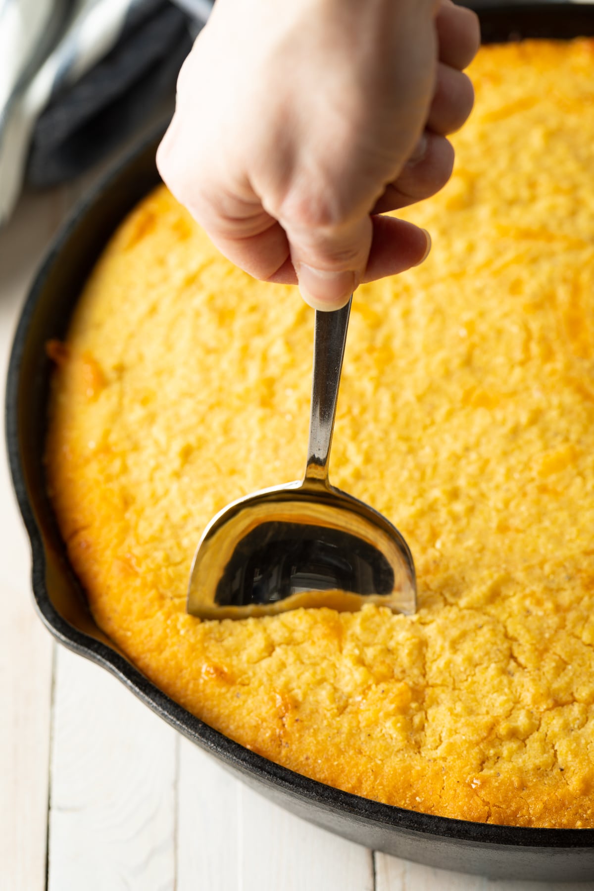 Cutting into Skillet Tamale Pie after it is baked. 